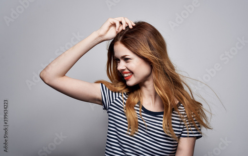 Pretty woman in white t-shirt emotions gestures with hands studio attractive look