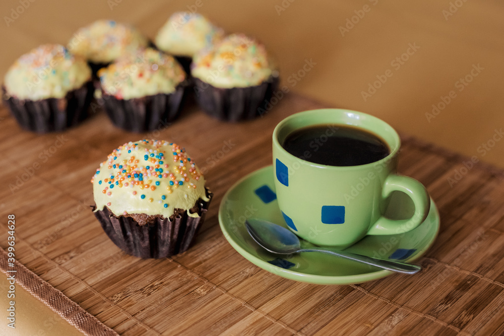 A cup of coffee with capkakes. A cup of coffee with capkakes.