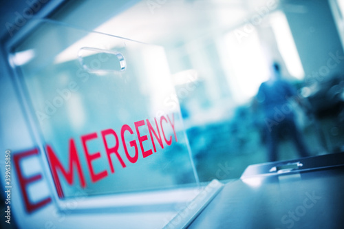 The inscription "urgency" on the plastic glass against the background of the hospital emergency room