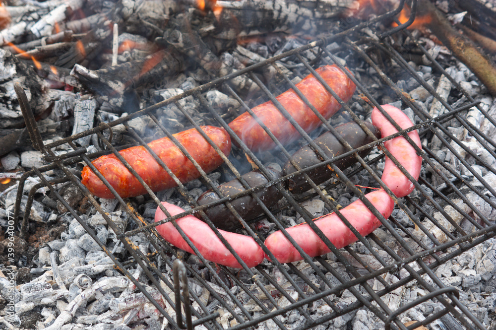 Grill with sausages on a barbecue in the countryside