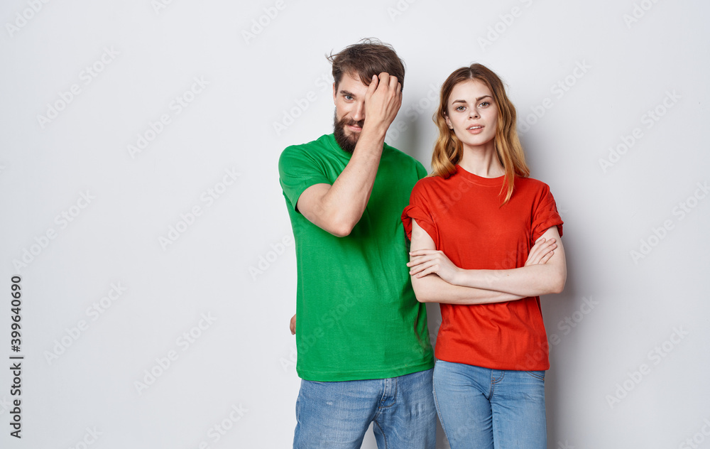 cute young couple in multicolored t-shirts hugs lifestyle fun isolated background cute young couple in multicolored t-shirts hugs lifestyle fun isolated background