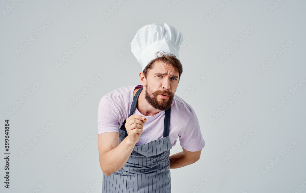 professional chef man in a headdress on a light background cropped view professional chef man in a headdress on a light background cropped view