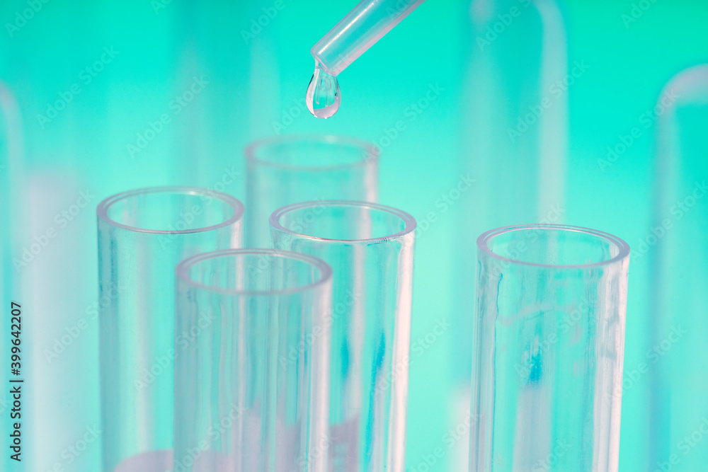DROP OF LIQUID FALLING FROM THE PIPETTE INTO THE TEST TUBES IN THE LABORATORY. RESEARCH AND DEVELOPMENT. PROGRESS IN SCIENCE. CONCEPT OF VACCINE AGAINST CORONAVIRUS. MUTATION, VARIANT AND NEW STRAIN. DROP OF LIQUID FALLING FROM THE PIPETTE INTO THE TEST TUBES IN THE LABORATORY. RESEARCH AND DEVELOPMENT. PROGRESS IN SCIENCE. CONCEPT OF VACCINE AGAINST CORONAVIRUS. MUTATION, VARIANT AND NEW STRAIN.