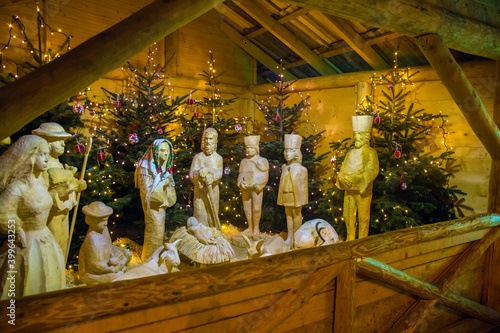 typical wooden statues of the birth of Jesus in a stable with a Christmas manger