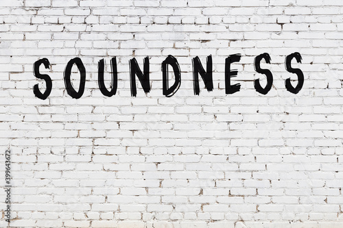 Inscription soundness painted on white brick wall