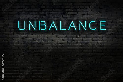 Fotografie Night view of neon sign on brick wall with inscription unbalance
