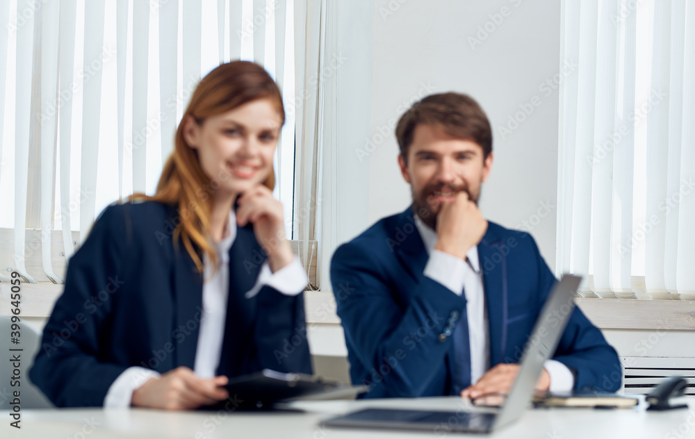 man and woman with laptop in office communication employees business finance man and woman with laptop in office communication employees business finance