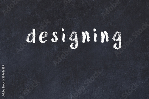 College chalk desk with the word designing written on in
