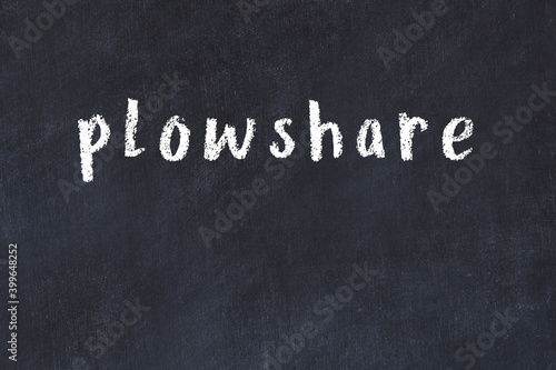 Valokuva College chalk desk with the word plowshare written on in