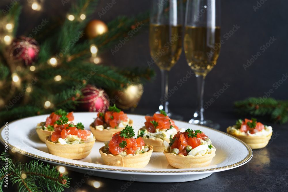 Tartlets stuffed with salad and salmon on a New Year's table. Tartlets stuffed with salad and salmon on a New Year's table.