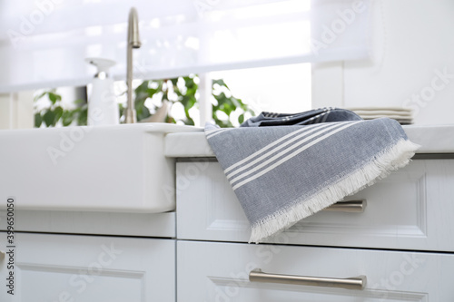 Photos Clean kitchen towel on counter at home, closeup