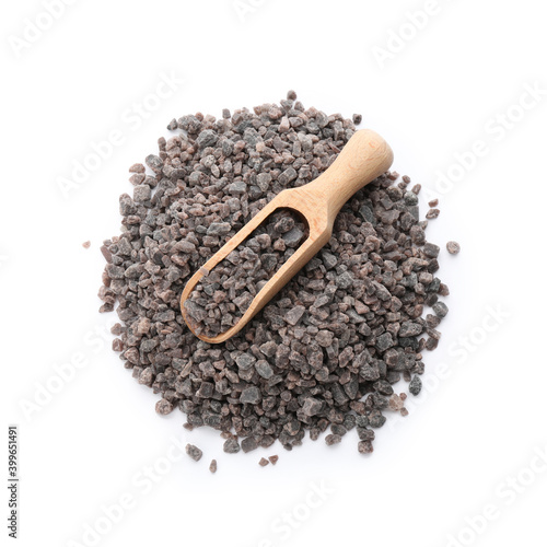 Pile of Himalayan black salt and wooden scoop isolated on white, top view