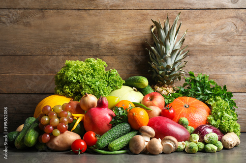 Assortment of fresh organic fruits and vegetables on grey table