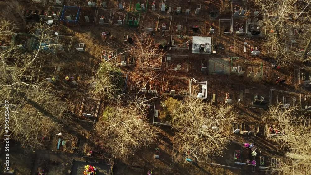 Aerial view of cemetery in late autumn. Bird's eye view of buried graves among trees. Aerial view of cemetery in late autumn. Bird's eye view of buried graves among trees.