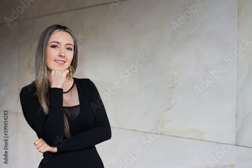 mujer elegante sonriendo a la camara con fondo amplio con espacio para letras. Mujer de negocios sonriendo, mujer emprendedora sonriendo, mujer segura de si misma