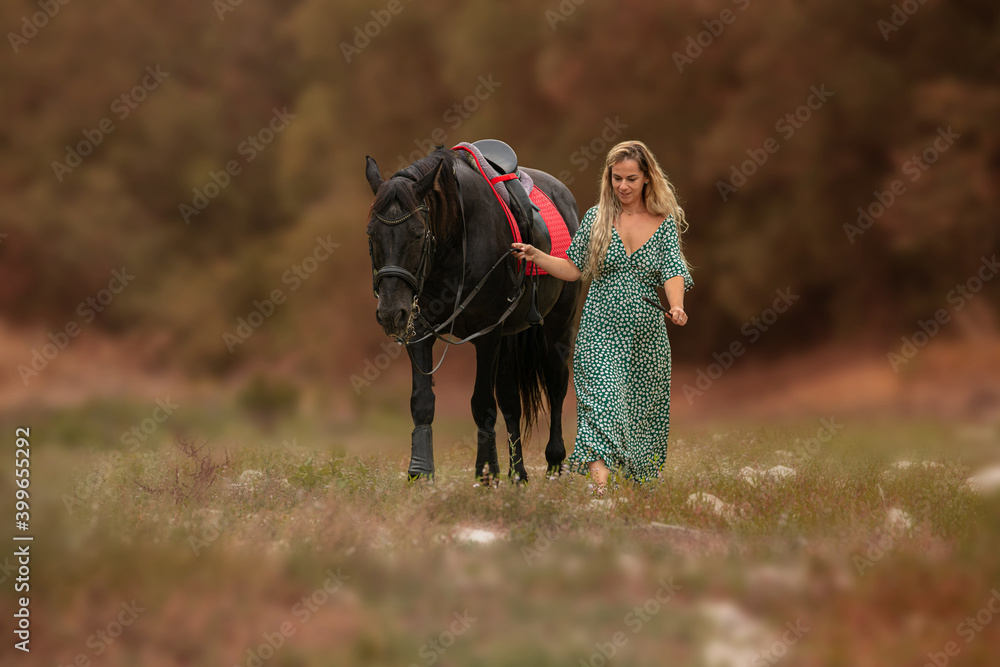 Fototapeta premium Woman in a dress with a black horse