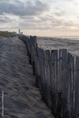 Sand fence on wide windy beach of North sea near Zandvoort in Netherlands