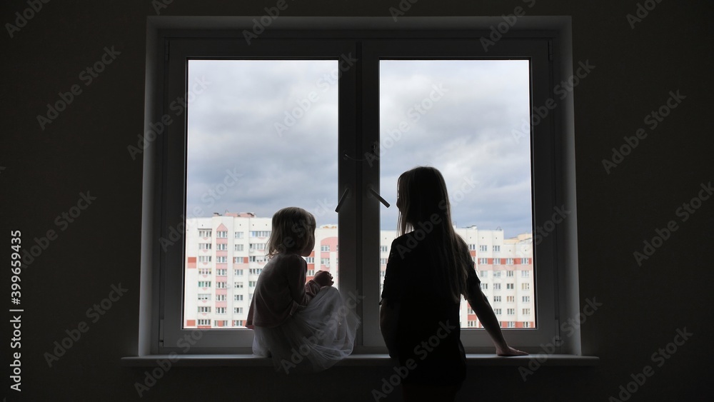 Mother comes to her lonely daughter who is sitting by the window. Mother comes to her lonely daughter who is sitting by the window.