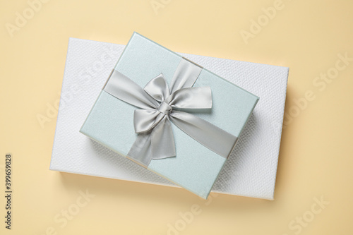 Beautiful gift boxes on beige background, top view