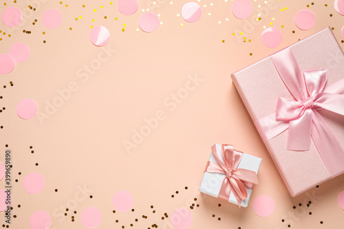 Frame of shiny confetti and beautiful gift boxes on color background  flat lay. Space for text