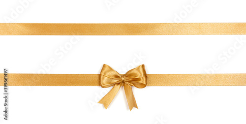 Golden satin ribbon with a bow isolated on white background. Decoration concept.