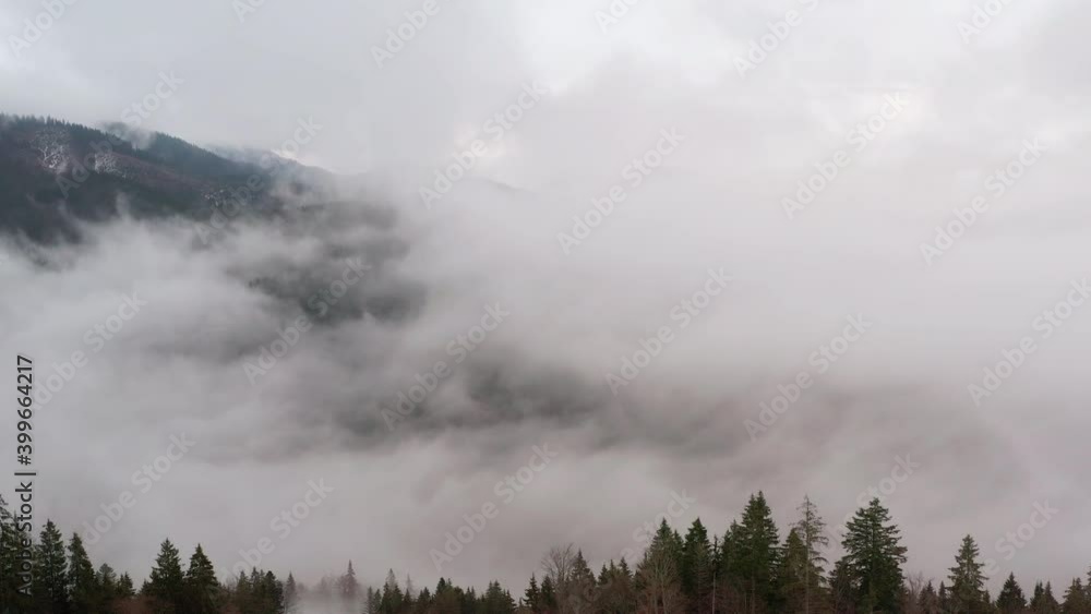 Aerial view. Mysterious mountain landscape on a cloudy autumn day. Foggy forest in the highlands. Natural background. Carpathian mountains. Cloudy gray winter landscape Aerial view. Mysterious mountain landscape on a cloudy autumn day. Foggy forest in the highlands. Natural background. Carpathian mountains. Cloudy gray winter landscape