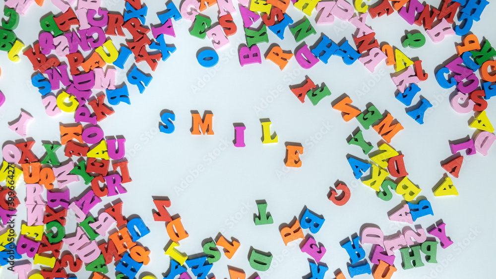 Multicolored Letters SMILE on The White Background. Letters of The Word Smile. Positive concept. Smile life is beautiful.