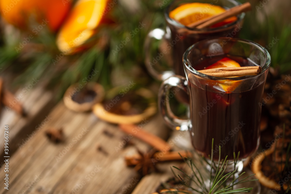 Appetizing christmas composition glasses of mulled wine on spruce cone and branch background. fragrant spices. Festive mood. Hot alcoholic drinks. View from above. Appetizing christmas composition glasses of mulled wine on spruce cone and branch background. fragrant spices. Festive mood. Hot alcoholic drinks. View from above.