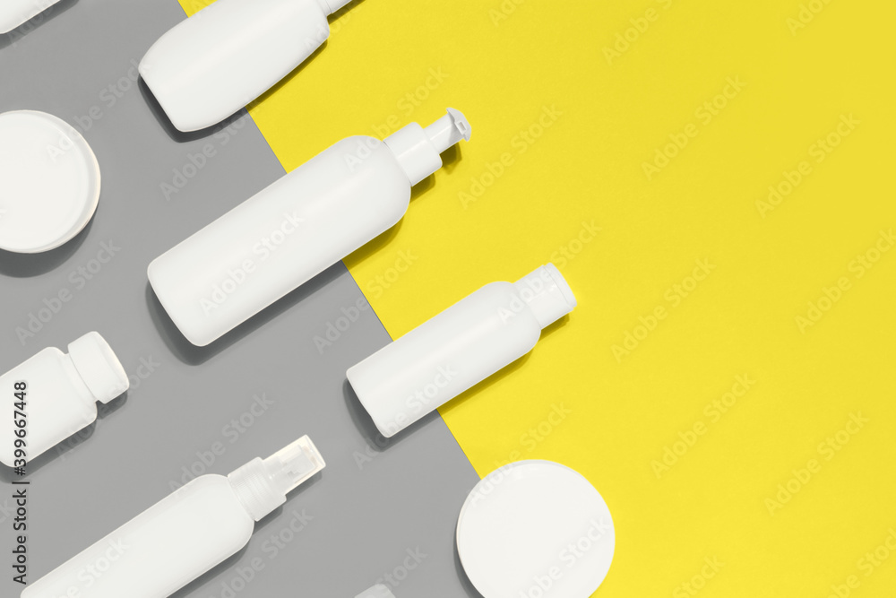 Cosmetic bottles and jar mockup pattern on Illuminating Yellow and Ultimate Gray background. Creative design demonstrating colors of the year 2021 Cosmetic bottles and jar mockup pattern on Illuminating Yellow and Ultimate Gray background. Creative design demonstrating colors of the year 2021