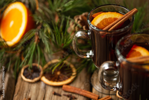 Macro shot view of appetizing christmas composition glasses of mulled wine on spruce cone and branch background. fragrant spices. Festive mood. Hot alcoholic drinks. View from above.