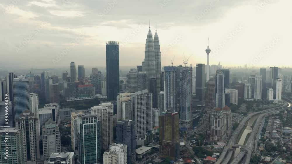 Dolly out aerial of Kuala Lumpur skyline, Petronas Twin Towers in backlight Dolly out aerial of Kuala Lumpur skyline, Petronas Twin Towers in backlight