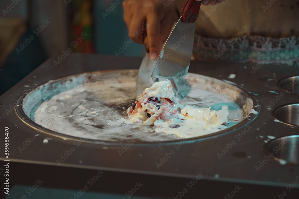 Fototapeta premium Process of making fried ice-cream dessert in night market. Thai famous gourmet street dessert food. Street food in Thailand.