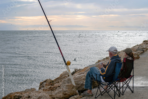 Senior Couple Relaxing and Fishing at Jetty 