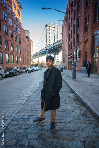 Sunshine day in New York City . Asian Teenage winter vacation at DUMBO NYC, Brooklyn Bridge, NYC.