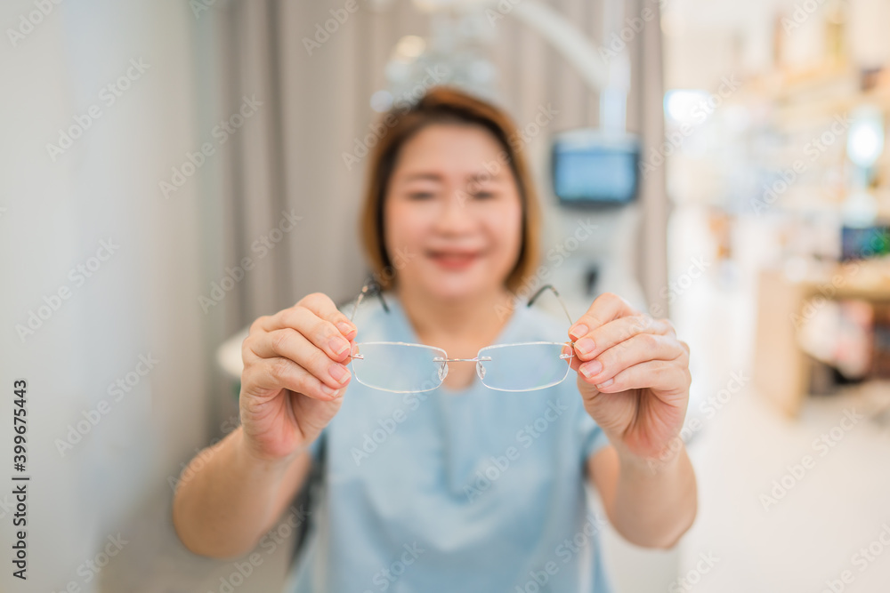 client testing her new eyeglasses with optometrist in optical store client testing her new eyeglasses with optometrist in optical store