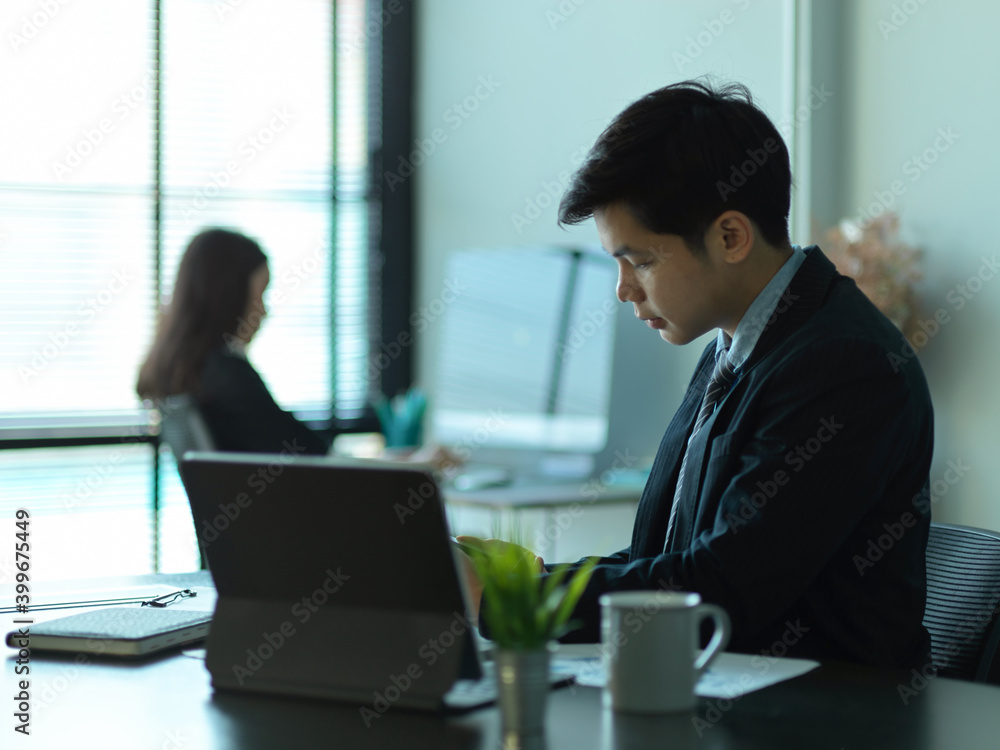 Businessman working with office supplies in modern office room Businessman working with office supplies in modern office room