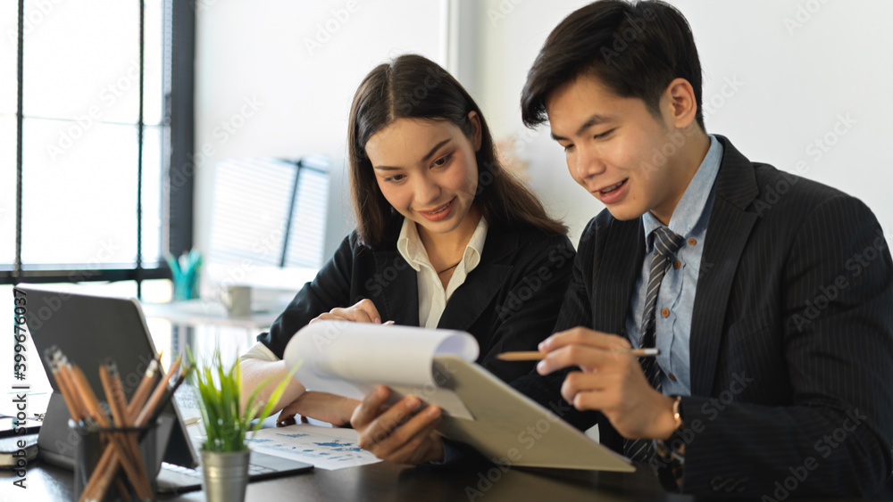 Business team consulting on their project with paperwork in office room Business team consulting on their project with paperwork in office room