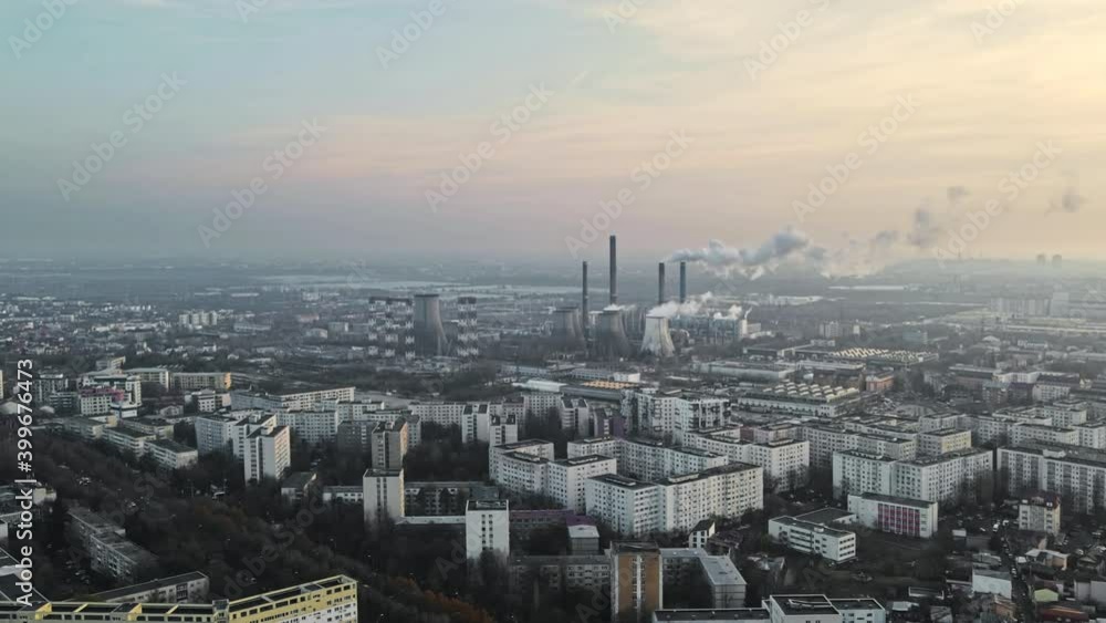 Cityscape of Bucharest from a drone, rows of residential buildings, thermal station with fog getting out and other the ground, ecology idea, Romania Cityscape of Bucharest from a drone, rows of residential buildings, thermal station with fog getting out and other the ground, ecology idea, Romania