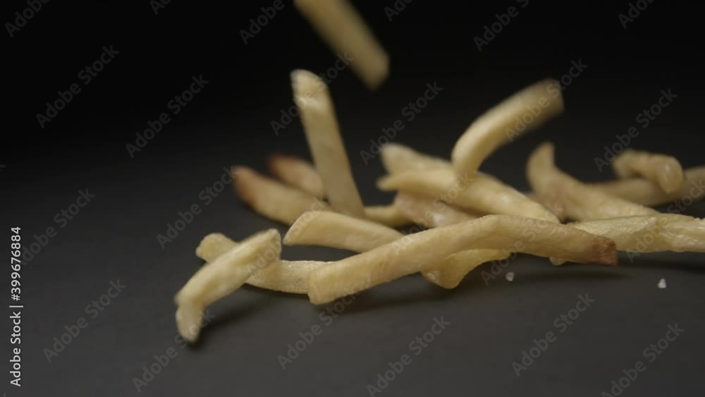 French fries with salt close up slow motion studio, tasty fast food French fries with salt close up slow motion studio, tasty fast food