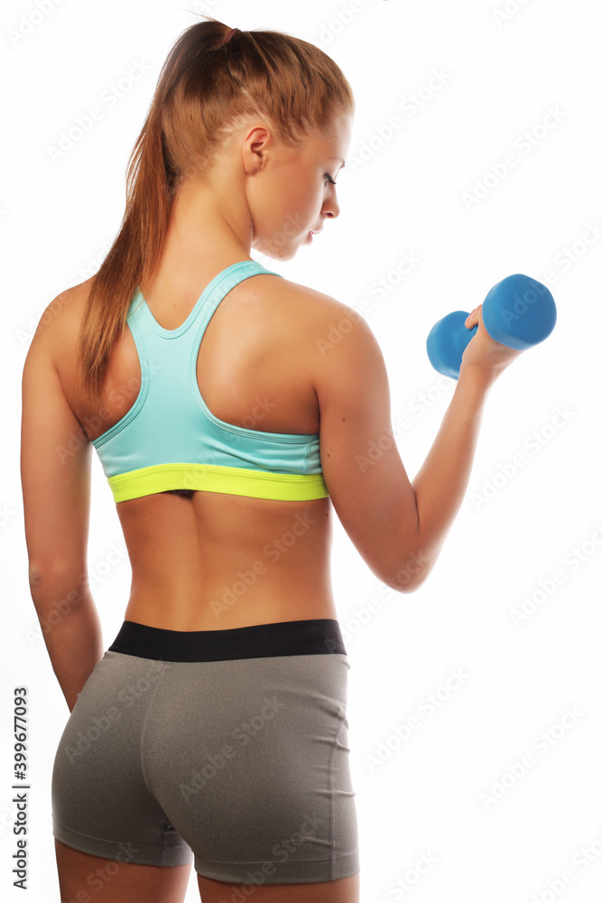 Young Woman in sport equipment practice with hand weights over white background Young Woman in sport equipment practice with hand weights over white background