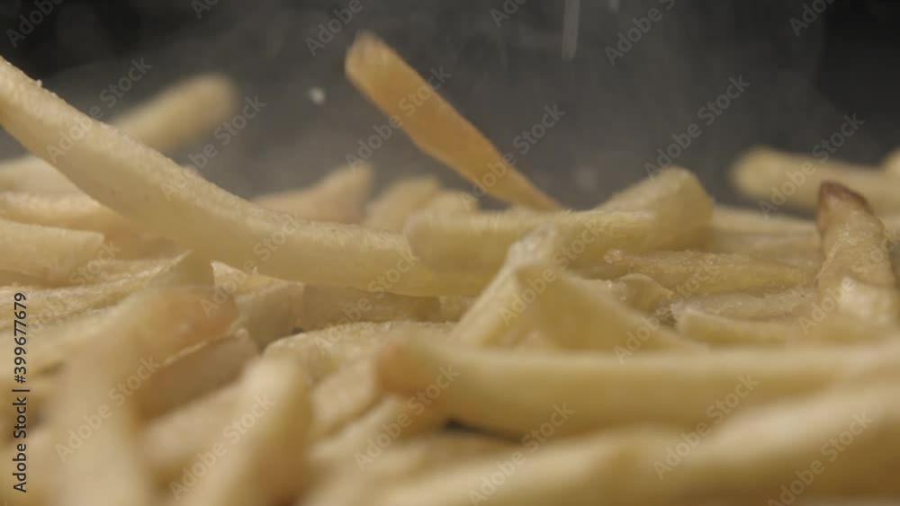 French fries with salt close up slow motion studio, tasty fast food French fries with salt close up slow motion studio, tasty fast food