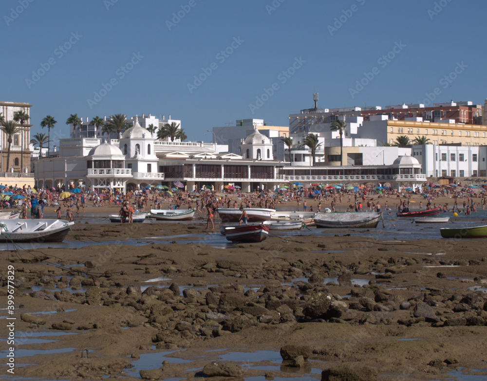 La Caleta beach, in Cadiz, with boats on the rocky bottom
