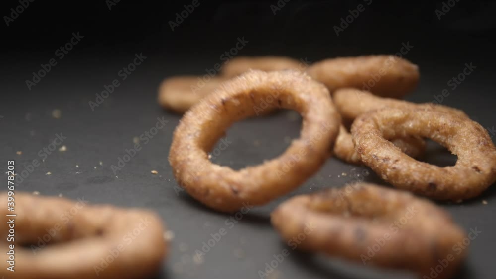 Onion rings close up slow motion studio, tasty fast food
Onion rings close up slow motion studio, tasty fast food