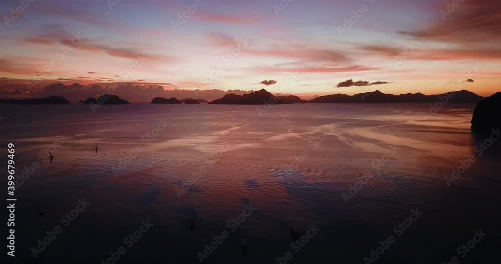 Aerial of colorful sunset over boats and sea, El Nido, Philippines Aerial of colorful sunset over boats and sea, El Nido, Philippines