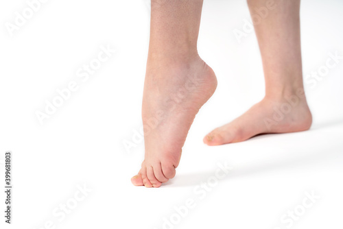 Close-up of naked woman's legs isolated on white background