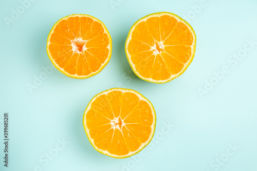 top view fresh tangerine slices lined on light-blue background photo color fruit orange citrus