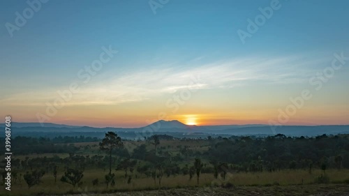 Time lapse video of Thung Salaeng Luang National Park Beautiful green hills glowing warm sunrise,Dramatic shine silhouette tree colorful warm above mountain at Phetchabun Province, Thailand