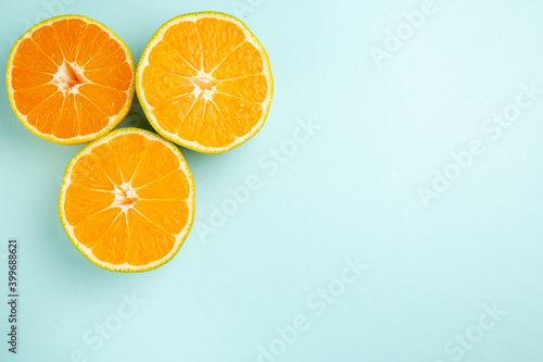 top view fresh tangerine slices on light-blue background photo color orange citrus fruit