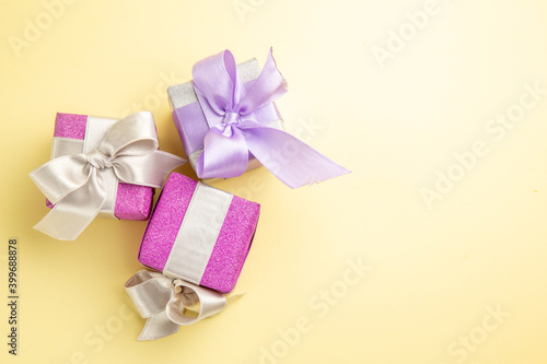 top view little presents on light-yellow background new year xmas gift photo color holiday