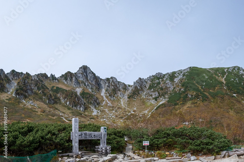 Panoramic view of Senjojiki Cirque in early autumn with signs leading the way to the footpath in Nagano Prefecture, Japan.
